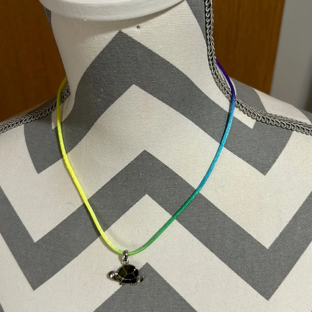 Kids 16” nylon ombré necklace with a silver turtle pendant green accents. Used